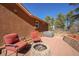 Charming patio featuring a cozy fire pit and two comfortable chairs, perfect for outdoor relaxation at 113 Oakdale Dr, Palmer Lake, CO 80133