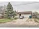 Charming home featuring a mature tree, inviting curb appeal, and an attached two-car garage at 6132 S Grant St, Centennial, CO 80121