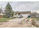 Charming home featuring a mature tree, inviting curb appeal, and an attached two-car garage at 6132 S Grant St, Centennial, CO 80121