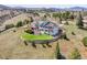 Majestic home with red accents features professional landscaping and a serene, mountainous backdrop at 260 Dekker Dr, Golden, CO 80401