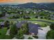 Expansive aerial view of a luxurious home with lush greenery, mountain views, and a long driveway at 260 Dekker Dr, Golden, CO 80401