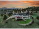 Wide aerial view of the home and its well-manicured, sloped yard with trees at 260 Dekker Dr, Golden, CO 80401