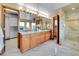 Spacious bathroom with double vanity, large mirror, and a glass-enclosed shower at 260 Dekker Dr, Golden, CO 80401