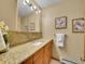 Elegant bathroom featuring a granite countertop, sink, and decorative mirror at 260 Dekker Dr, Golden, CO 80401