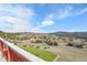 Expansive mountain views visible from the outdoor deck, surrounded by lush trees and neighborhood at 260 Dekker Dr, Golden, CO 80401