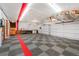 Spacious garage with checkerboard floor and overhead storage racks at 260 Dekker Dr, Golden, CO 80401
