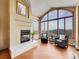 Cozy living room features a fireplace, lots of natural light, and views of the lush, mountainous landscape at 260 Dekker Dr, Golden, CO 80401