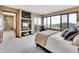 Comfortable main bedroom featuring a fireplace, TV, mountain views, and ensuite bathroom at 260 Dekker Dr, Golden, CO 80401