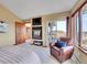 Cozy bedroom with a fireplace, balcony access, and comfortable chair at 260 Dekker Dr, Golden, CO 80401