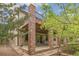 Back exterior showcasing a covered patio with brick pillars and an upper deck with glass railings at 6085 Nile Cir, Golden, CO 80403