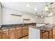 Basement bar area with granite countertops, wooden cabinets, and pendant lighting at 6085 Nile Cir, Golden, CO 80403