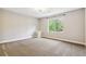 Neutral bedroom features plush carpeting and a window offering a view of the lush greenery outside at 6085 Nile Cir, Golden, CO 80403