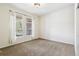 Bright bedroom featuring two windows, neutral walls, and plush carpet at 6085 Nile Cir, Golden, CO 80403