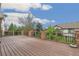Wide-angle of spacious deck with metal and brick supports and lush landscaping at 6085 Nile Cir, Golden, CO 80403