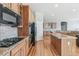 A well-equipped kitchen with wood cabinetry, stainless steel appliances, granite countertops, and hardwood floors at 6085 Nile Cir, Golden, CO 80403