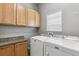 Well-organized laundry room features modern appliances and ample storage with upper cabinets and a granite countertop at 6085 Nile Cir, Golden, CO 80403