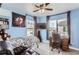 This bedroom includes space for study and relaxation. Features include ceiling fan and large windows at 5570 Nepal St, Denver, CO 80249