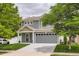 Charming two-story home featuring a well-maintained lawn, gray siding, and an attached two-car garage at 5570 Nepal St, Denver, CO 80249