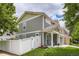 Charming two-story home with well-manicured lawn, fenced yard, and a welcoming entryway for guests at 5570 Nepal St, Denver, CO 80249
