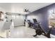 A versatile room offering space for a home gym and office setup with ample natural light at 5570 Nepal St, Denver, CO 80249