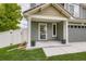 Inviting covered front porch with lovely plants and view of the exterior of the house at 5570 Nepal St, Denver, CO 80249