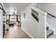 Bright hallway features modern wall accents, stairwell, and access to the living room at 5570 Nepal St, Denver, CO 80249