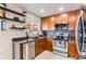 Well-lit kitchen showcasing stainless steel appliances, granite countertops, and sleek cabinetry at 5570 Nepal St, Denver, CO 80249