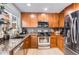 Functional kitchen featuring stainless steel appliances, updated countertops, and plenty of storage space at 5570 Nepal St, Denver, CO 80249