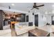 Open-concept living room flows into the kitchen, featuring hardwood floors and comfortable furniture at 5570 Nepal St, Denver, CO 80249