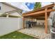 Spacious outdoor patio with stone flooring, complete with a wooden pergola and multiple grilling stations at 5570 Nepal St, Denver, CO 80249