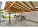 Outdoor patio with stone flooring, complete with a wooden pergola and multiple grilling stations at 5570 Nepal St, Denver, CO 80249