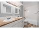 Well-lit bathroom features dual sinks, granite countertop, tiled backsplash and tub, and modern fixtures at 12191 Melody Dr # 301, Westminster, CO 80234