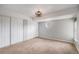 Spacious bedroom features neutral carpet, gray walls, a modern ceiling light fixture, and ample closet space at 12191 Melody Dr # 301, Westminster, CO 80234