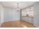 Dining area with wood floors, chandelier lighting, and an open concept to the kitchen at 12191 Melody Dr # 301, Westminster, CO 80234