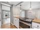 Open concept kitchen features modern appliances, ample counter space, and wood flooring throughout the living space at 12191 Melody Dr # 301, Westminster, CO 80234