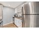 Efficient kitchen with stainless steel appliances, white cabinetry, and wood flooring at 12191 Melody Dr # 301, Westminster, CO 80234