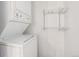 Bright laundry features modern stacked washer and dryer with convenient shelving, maximizing space and functionality at 12191 Melody Dr # 301, Westminster, CO 80234