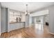 Open-concept space with wood floors, fireplace, kitchen with stainless appliances and a dining area at 12191 Melody Dr # 301, Westminster, CO 80234