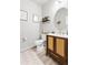 Charming half bathroom featuring decorative decor, a mirror, and a vanity with storage at 244 Chipeta Way, Lochbuie, CO 80603