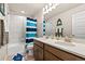 A bathroom with a double vanity, tiled shower and fun nautical decor at 244 Chipeta Way, Lochbuie, CO 80603