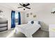A bright bedroom is adorned with blue curtains and a peace sign pillow at 244 Chipeta Way, Lochbuie, CO 80603