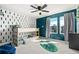 Modern bedroom features a bunk bed, a ceiling fan, and a window with natural light at 244 Chipeta Way, Lochbuie, CO 80603