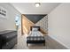 A cozy bedroom features a graphic accent wall and coordinating furniture at 244 Chipeta Way, Lochbuie, CO 80603