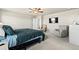 Spacious bedroom featuring a ceiling fan, TV, and comfortable seating, offering a relaxing retreat at 244 Chipeta Way, Lochbuie, CO 80603
