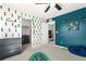 A stylish bedroom features unique wall designs, a ceiling fan, and a closet at 244 Chipeta Way, Lochbuie, CO 80603