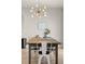 Bright dining room features a modern chandelier and ample space for entertaining guests at 244 Chipeta Way, Lochbuie, CO 80603