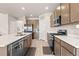 Bright kitchen boasts modern appliances, island sink, and an abundance of cabinet space at 244 Chipeta Way, Lochbuie, CO 80603
