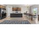 Modern kitchen featuring an island, stainless steel appliances, and adjacent dining area at 244 Chipeta Way, Lochbuie, CO 80603