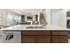 Open concept kitchen with island sink and stainless steel dishwasher overlooking living room and stairway at 244 Chipeta Way, Lochbuie, CO 80603