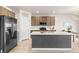 Modern kitchen featuring an island, stainless steel appliances, and open concept at 244 Chipeta Way, Lochbuie, CO 80603